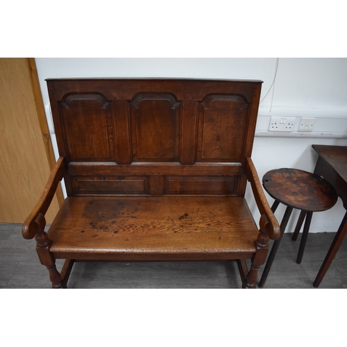 4176 - A 17th Century revival oak three panel back hall settle the scroll arms on turned supports united by... 