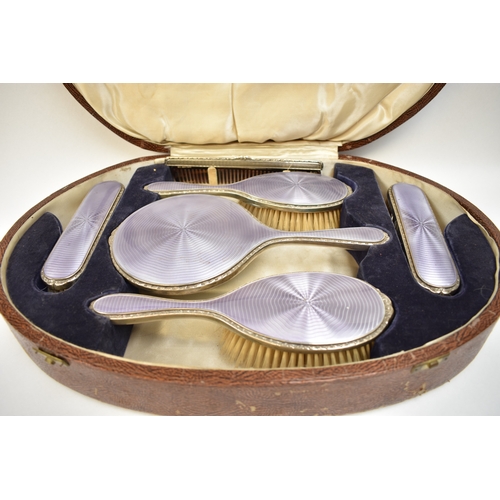 8031 - A cased Walker and Hall dressing table set, art deco purple guilloche design with silver rims, inclu... 