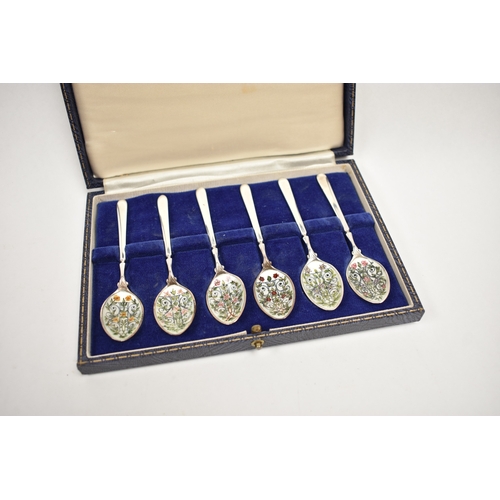 8051 - A Cohen & Charles set of six silver coffee / tea spoons, the bowls hand painted with scrolled foliag... 