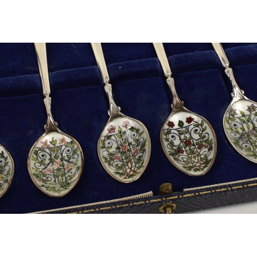 8051 - A Cohen & Charles set of six silver coffee / tea spoons, the bowls hand painted with scrolled foliag... 