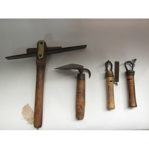 4257 - A collection of bygone tools to include a mill stone scutch and a pig scraper