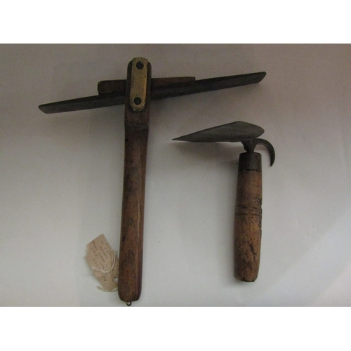 4257 - A collection of bygone tools to include a mill stone scutch and a pig scraper