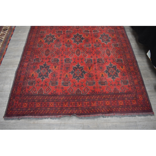 1024 - A Persian hand woven rug the central field decorated with various motifs including guls, flowers, st... 