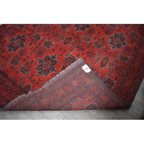 1024 - A Persian hand woven rug the central field decorated with various motifs including guls, flowers, st... 