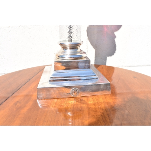 1011 - A late 19th Century French cranberry glass oil lamp with Art Nouveau moulded shade, above cranberry ... 