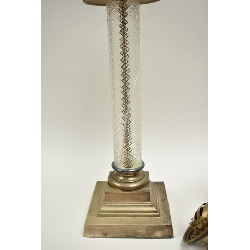 1011 - A late 19th Century French cranberry glass oil lamp with Art Nouveau moulded shade, above cranberry ... 