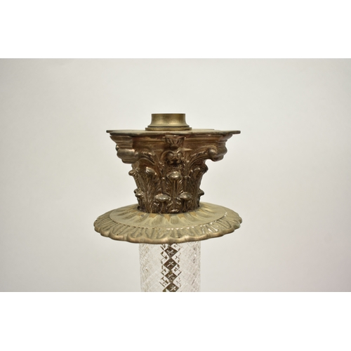 1011 - A late 19th Century French cranberry glass oil lamp with Art Nouveau moulded shade, above cranberry ... 