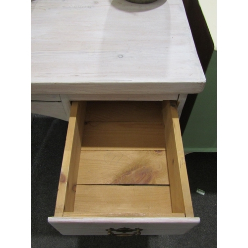 1033 - A lime wash pine twin pedestal desk of six drawers, 76cm tall x 106cm wide x 55cm deep