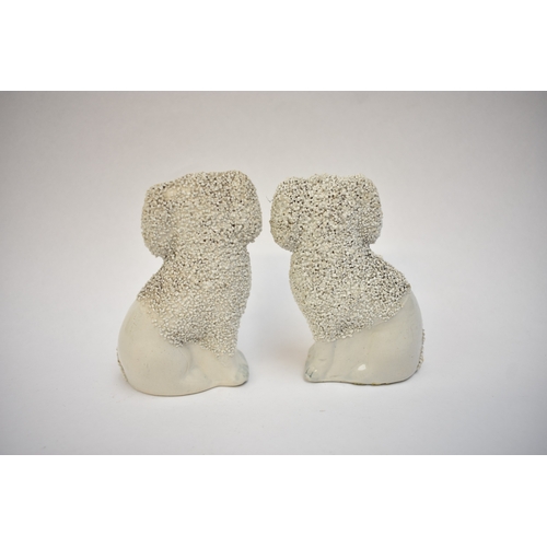 1051 - A pair of 19th Century Staffordshire poodles and two others, one holding a basket in its mouth, 12cm... 