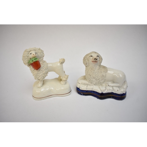1051 - A pair of 19th Century Staffordshire poodles and two others, one holding a basket in its mouth, 12cm... 