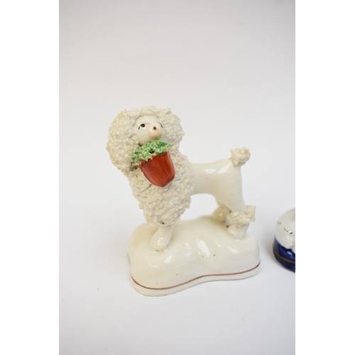 1051 - A pair of 19th Century Staffordshire poodles and two others, one holding a basket in its mouth, 12cm... 