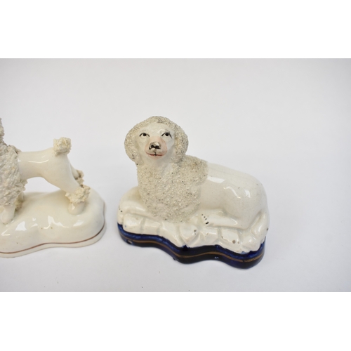 1051 - A pair of 19th Century Staffordshire poodles and two others, one holding a basket in its mouth, 12cm... 