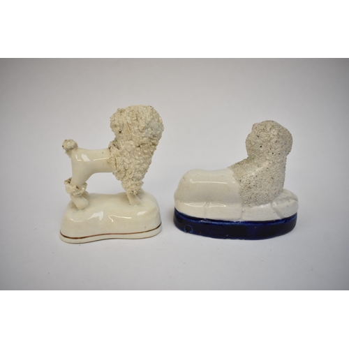 1051 - A pair of 19th Century Staffordshire poodles and two others, one holding a basket in its mouth, 12cm... 