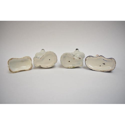 1051 - A pair of 19th Century Staffordshire poodles and two others, one holding a basket in its mouth, 12cm... 