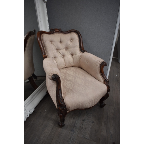 1022 - An early-mid 19th century rosewood ladies button back armchair, the shaped scroll back leading to ac... 