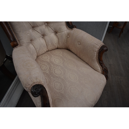 1022 - An early-mid 19th century rosewood ladies button back armchair, the shaped scroll back leading to ac... 