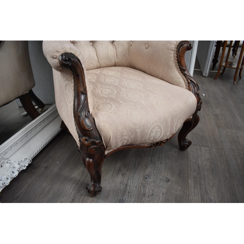 1022 - An early-mid 19th century rosewood ladies button back armchair, the shaped scroll back leading to ac... 