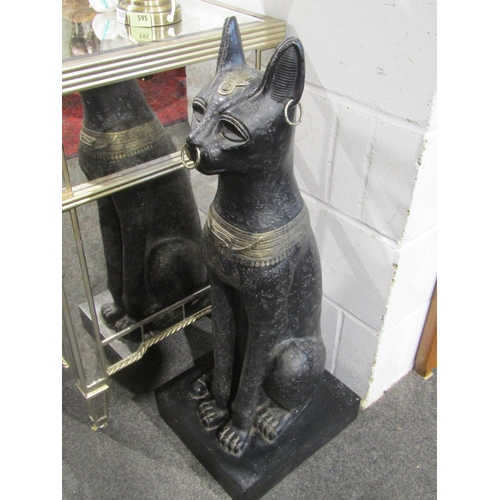 1025 - A pair of Egyptian seated Bastet figures on plinth bases, 88cm height