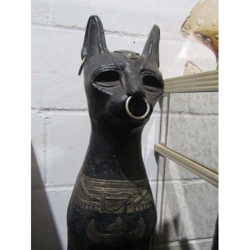 1025 - A pair of Egyptian seated Bastet figures on plinth bases, 88cm height