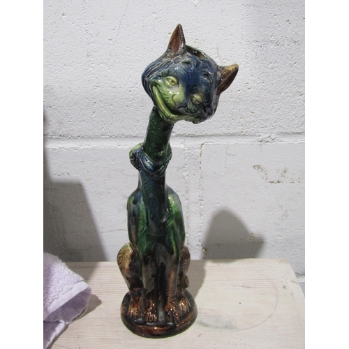 1034 - A pair of pottery cat candlesticks, necks a/f