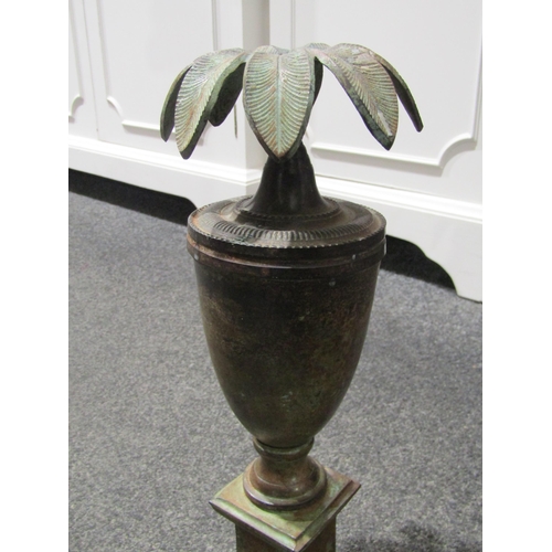 1041 - A pair of copper effect urn form candlesticks, 34cm tall