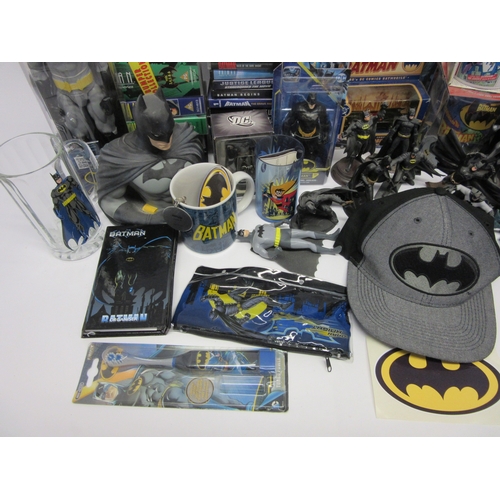 6019 - A collection of Batman memorabilia to include figures, clothing, DVDs and videos, Corgi Batmobile, e... 