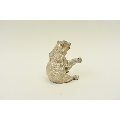 5037 - A hollow cast silver seated bear with its arms outstretched, London 1967, maker SMD, weighted base, ... 