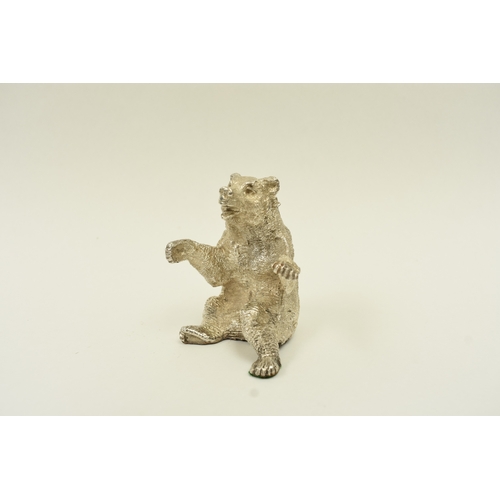 5037 - A hollow cast silver seated bear with its arms outstretched, London 1967, maker SMD, weighted base, ... 