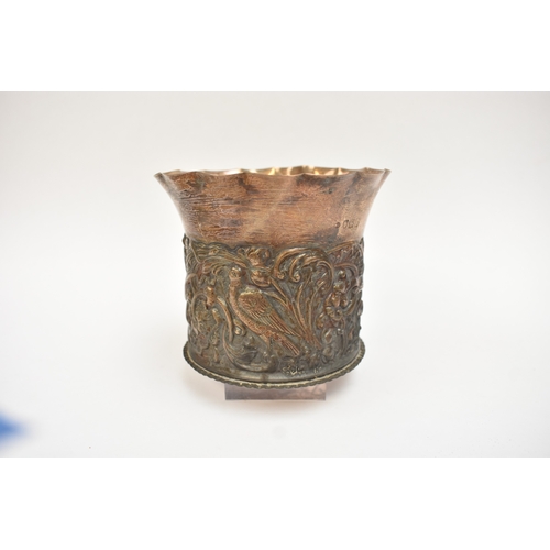 5052 - A William Comyns & Sons silver pot with frilled edge, slightly dented, the body embossed with birds ... 