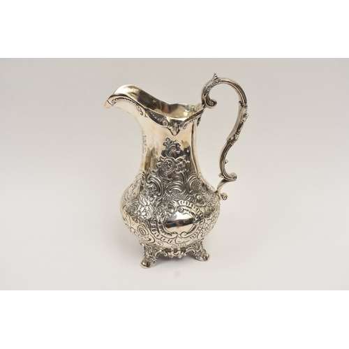 5019 - A William Hunter silver large milk jug with embossed floral and leaf detail, vacant cartouche, Londo... 