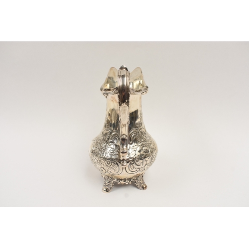 5019 - A William Hunter silver large milk jug with embossed floral and leaf detail, vacant cartouche, Londo... 