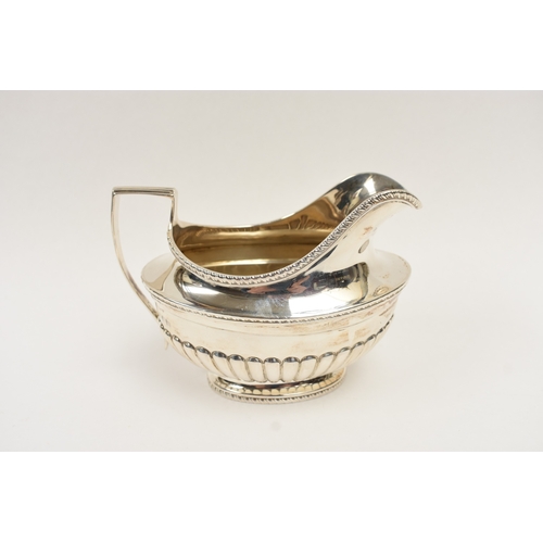5011 - C.S. Harris & Sons Ltd silver sauce boat with melon-fluted detail, London 1927, 10cm tall x 14.5cm l... 