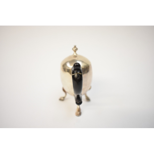 5054 - A Harry Freeman silver hot milk jug with detachable lid and treen handle (split and glued) raised on... 