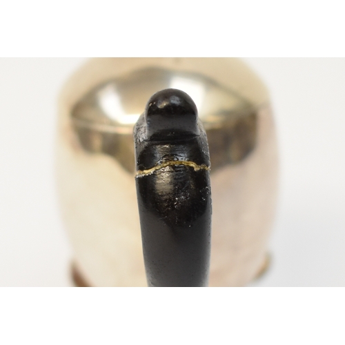 5054 - A Harry Freeman silver hot milk jug with detachable lid and treen handle (split and glued) raised on... 