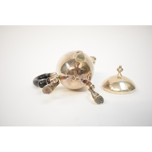 5054 - A Harry Freeman silver hot milk jug with detachable lid and treen handle (split and glued) raised on... 