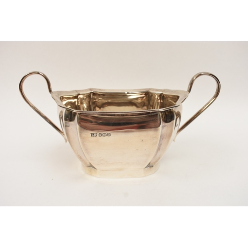 5008 - An L Harrison silver three piece tea set of classical form with ebony knop and handle, the sugar bow... 