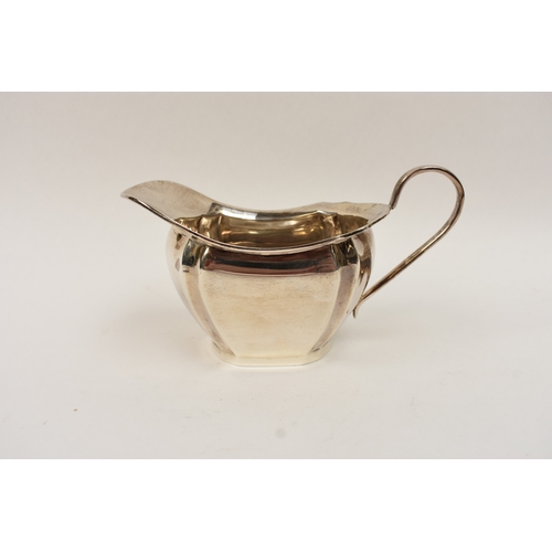 5008 - An L Harrison silver three piece tea set of classical form with ebony knop and handle, the sugar bow... 