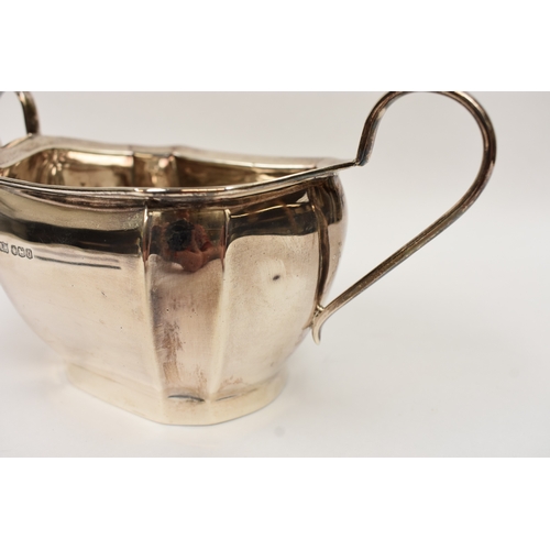 5008 - An L Harrison silver three piece tea set of classical form with ebony knop and handle, the sugar bow... 