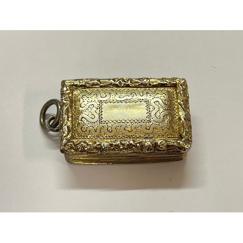 5112 - A William IV silver gilt vinaigrette fob, the foliate and floral edge with wavy and dappled engravin... 