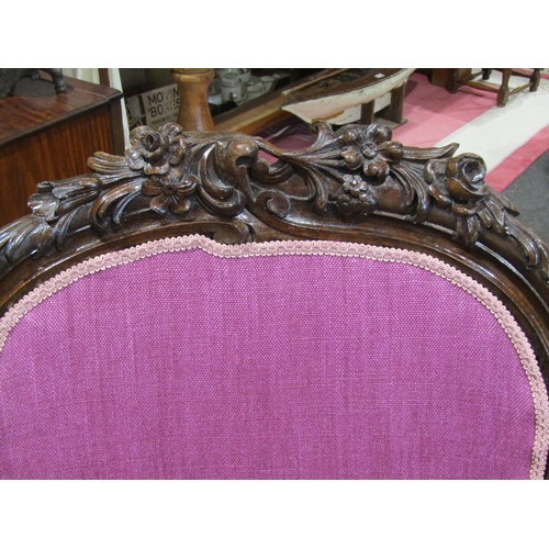 1022 - A mahogany balloon back chair on cabriole legs with brass castor wheels