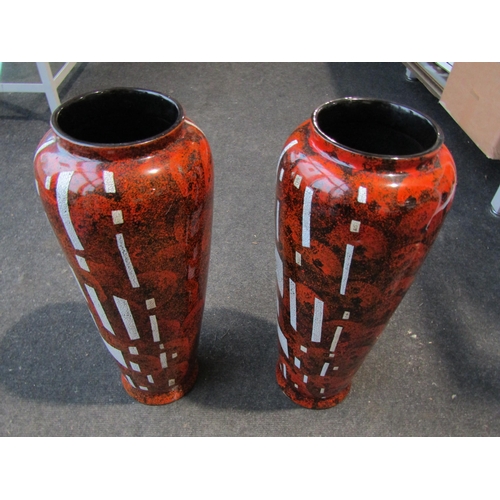 1003 - A pair of lacquered vases, orange/black and white mottled design, 50cm tall