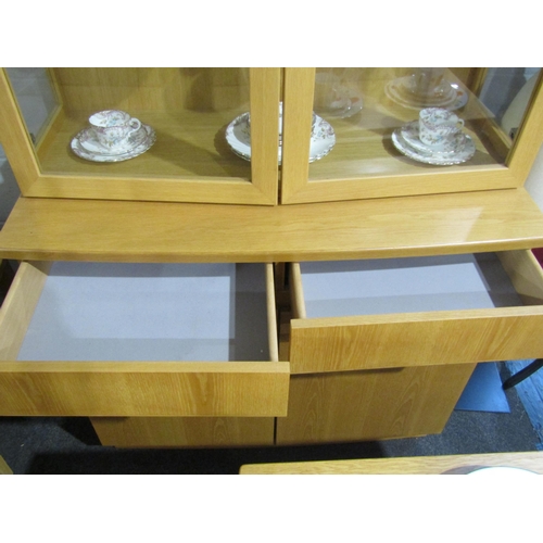 1006 - An oak lounge cabinet, the two glazed doors over a two drawer and two door cupboard base, 196cm tall... 