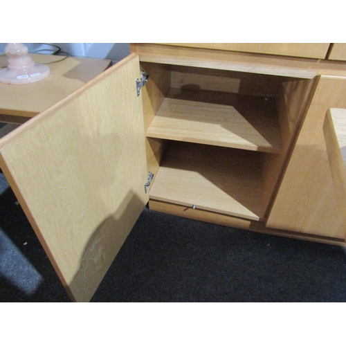 1006 - An oak lounge cabinet, the two glazed doors over a two drawer and two door cupboard base, 196cm tall... 