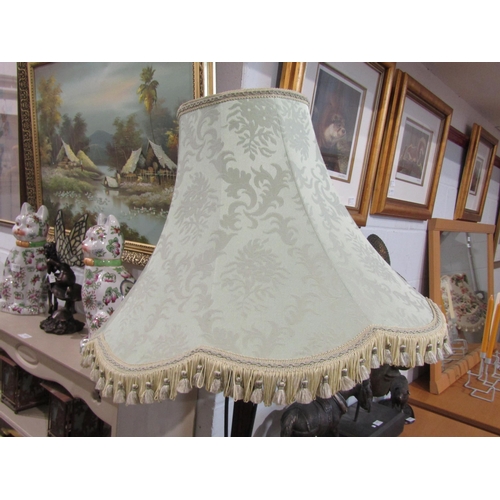 1017 - A mahogany standard lamp with fluted column, tasselled shade