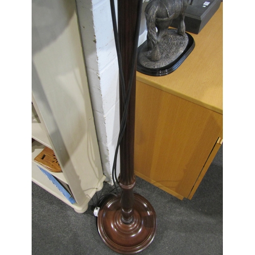 1017 - A mahogany standard lamp with fluted column, tasselled shade