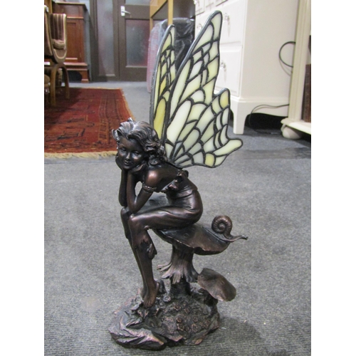 1029 - A bronze effect fairy figure with glass wings, sitting upon a toadstool with snail, 34cm tall, and t... 