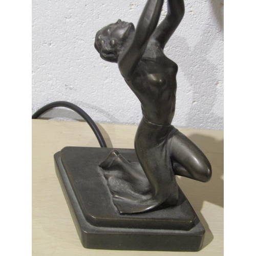 1038 - An Art Deco figural table lamp with pink leaded glass shade