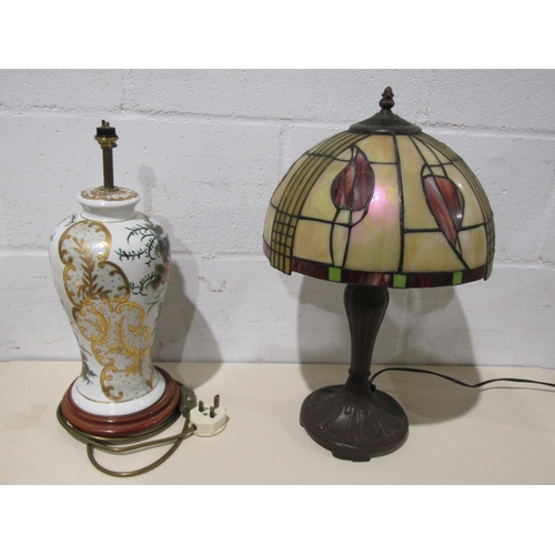 1045 - A Tiffany style lamp, a ceramic gilt lamp with wood base and an Italian lamp with red tasseled shade... 