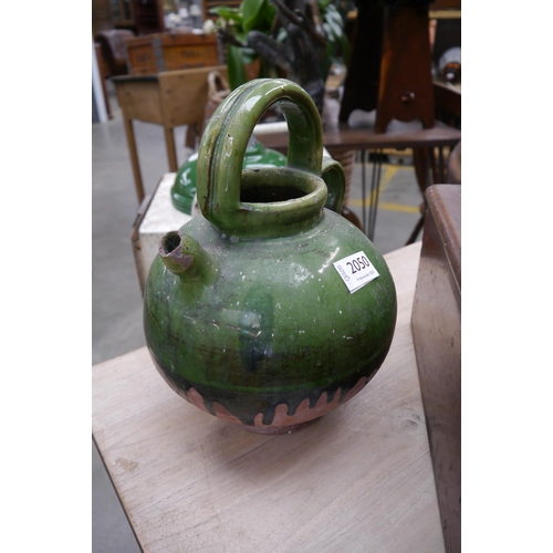 2050 - A green glazed pottery water jug
