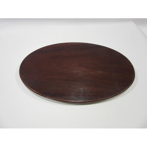 An inlaid mahogany oval waiter with wavy gallery edge, 35cm long